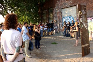 Dupont Bike Mural Launch: A crowd gathers around the Art Starts artists on the West Toronto Railpath during the opening celebration for the new cycling-themed mural on Dupont St. at Dundas St.