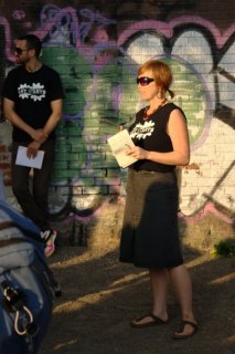 Dupont Bike Mural Launch: Liz Forsberg, local resident and managing director of Art Starts addresses the crowd gathered on the Railpath for the Dupont cycling mural launch party.