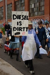  One of the marchers carrying a "Diesel is Dirty" placard.